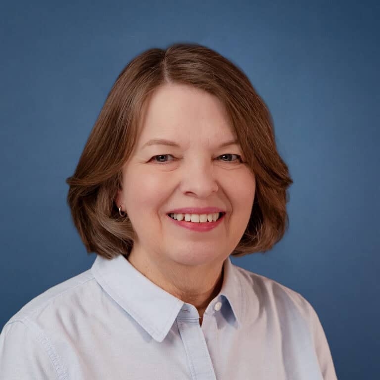 Portrait of Joni Prize, Christ Community Church leader, smiling warmly.