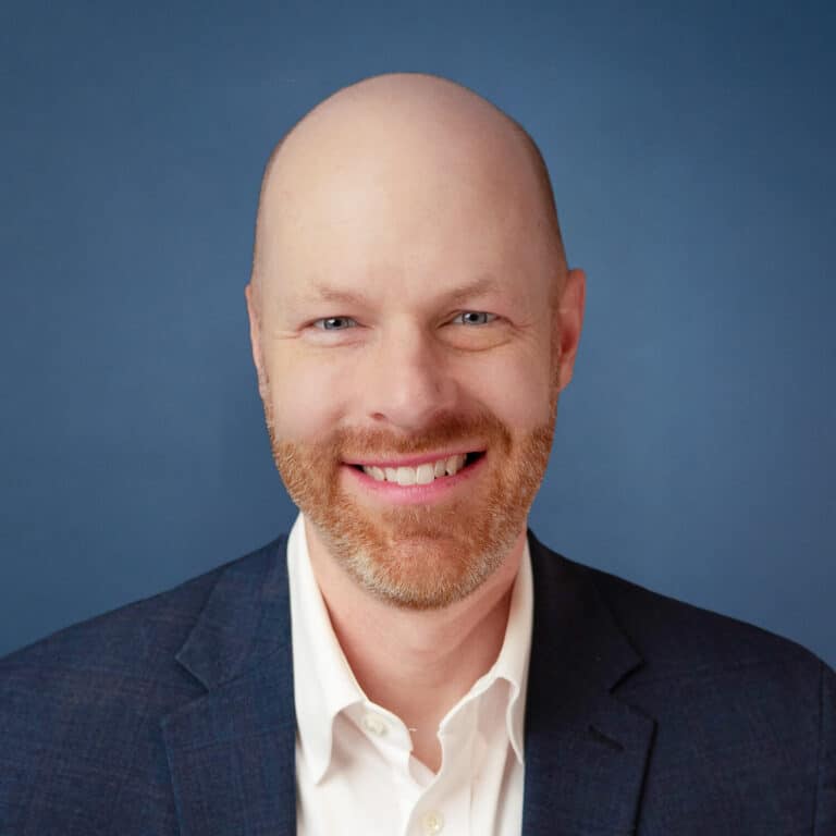 Headshot of Bill Gorman smiling in a suit