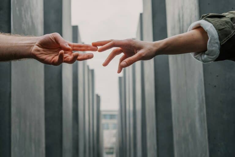 Fingers reaching in Holocaust Memorial, Berlin. Connection in remembrance.