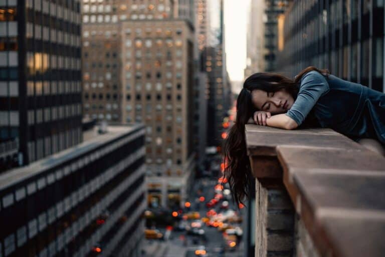Woman resting on rooftop with city view. Revering work and rest.