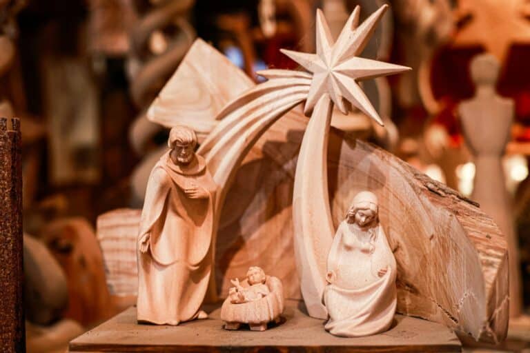 Wooden nativity scene with Mary, Joseph, baby Jesus, and the Star of Bethlehem.