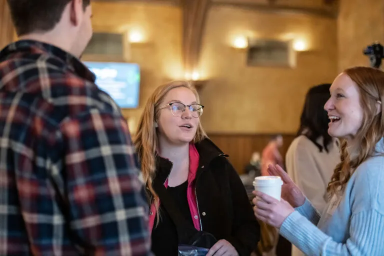 People talking at Brookside Campus, Christ Community Church. Woman holding a coffee cup.