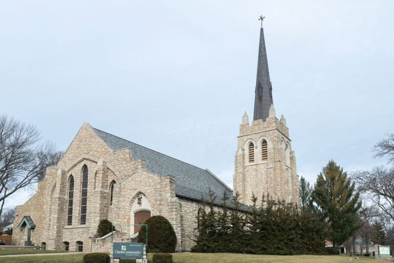 Christ Community Church exterior with stone facade and tall steeple.