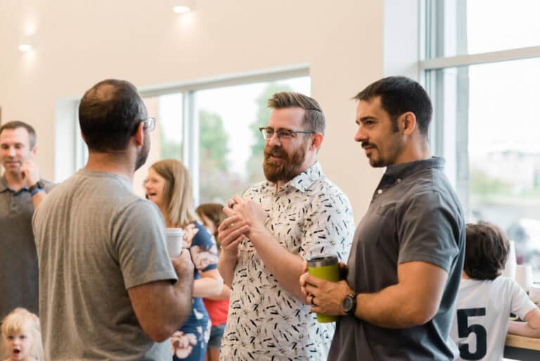 Men's Ministries event: Men talking and drinking coffee at church.