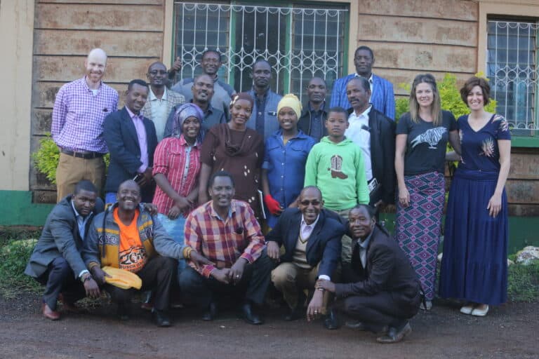 Group photo from Outreach event, diverse people smiling together