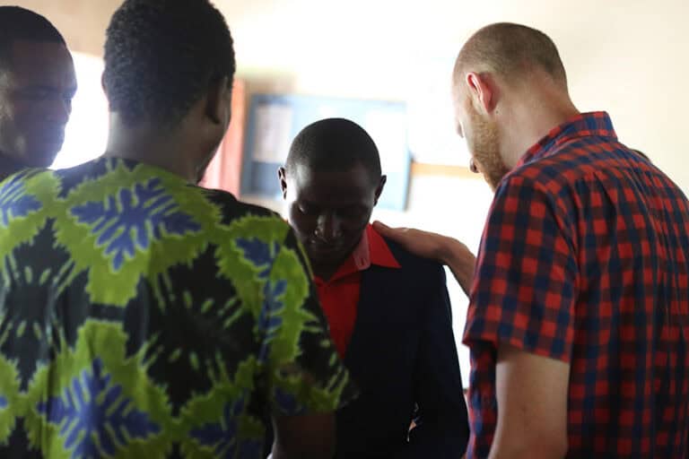 Group praying together during outreach event.