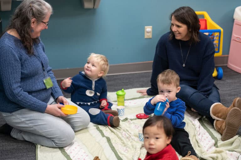 Adults and toddlers on a blanket at Christ Community Church Leawood Campus.