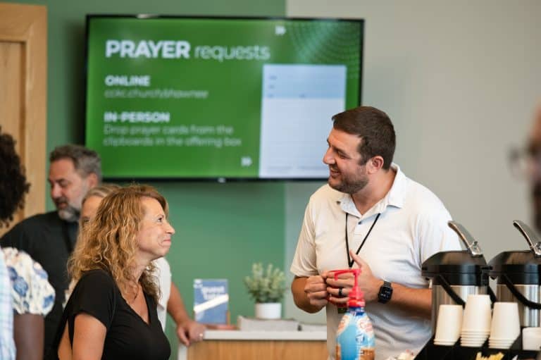 Shawnee Campus pastor talks to congregants in lobby